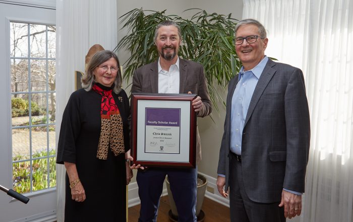 Chris Smeenk holds his faculty scholar award with Sarah Pritchard, and Alan Shepard, Western University Provost and President, respectively