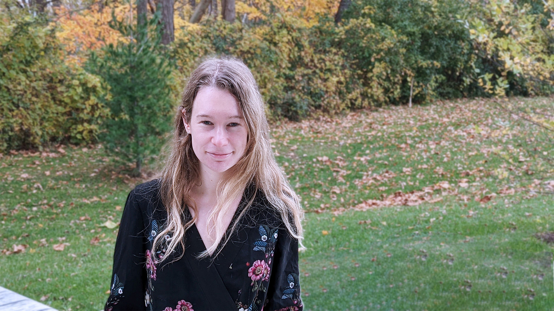 Photo of Emily Adlam in front of fall trees behind WIRB