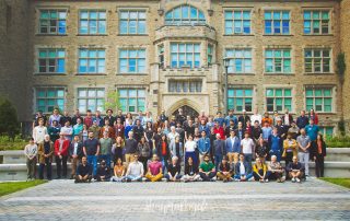 Group photo of QISS2022 conference attendees in front of Physics & Astronomy Building