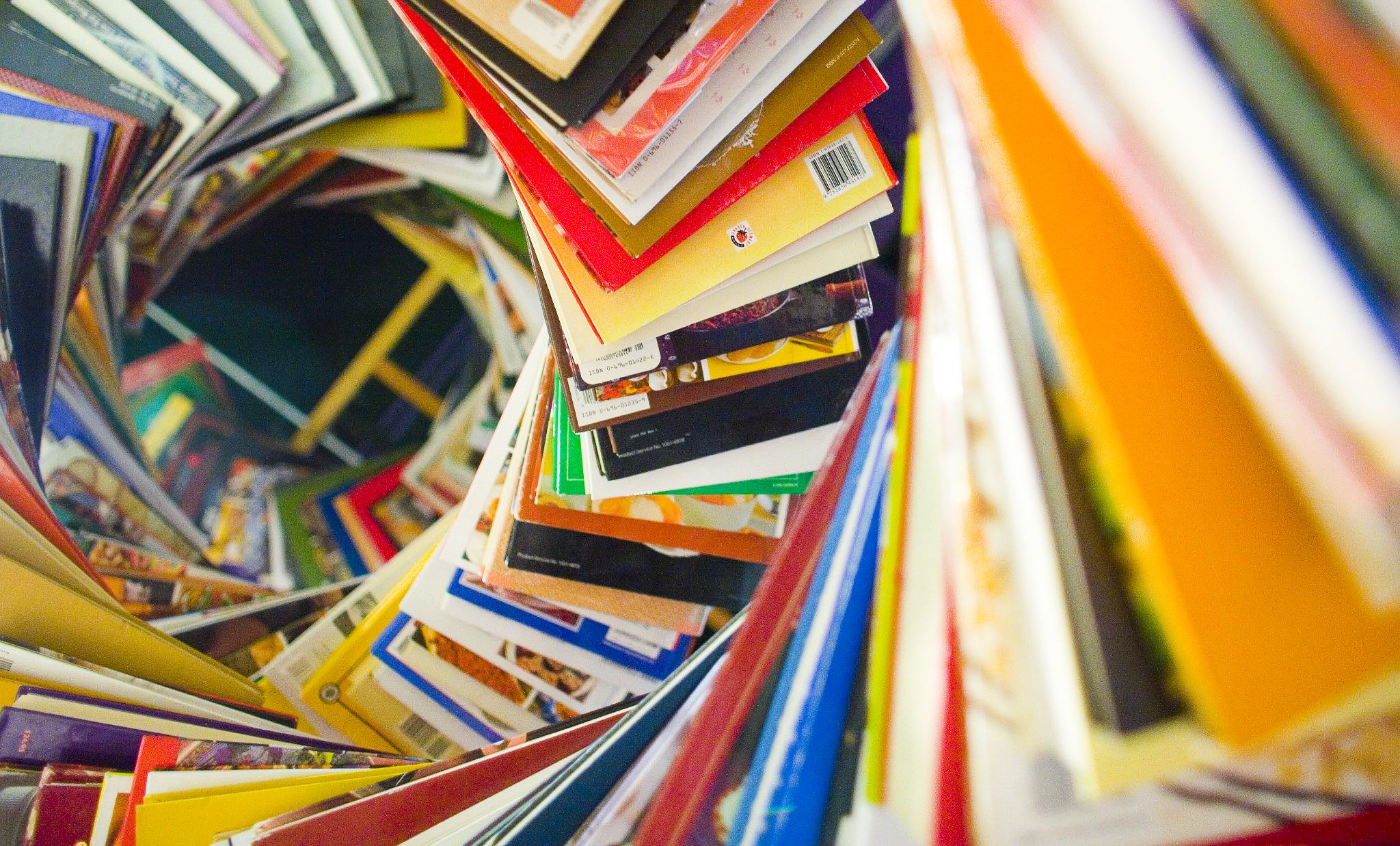 Library books stacked in a helix and photographed from the top