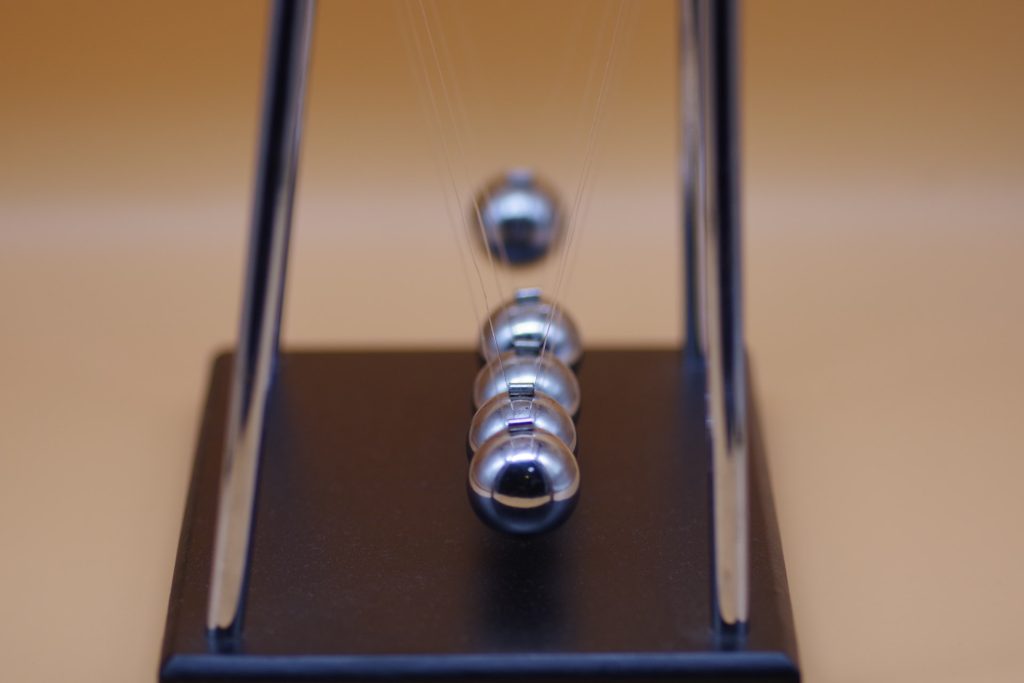 nadir-syzygy-wc3jFFQxo8k-unsplash Picture of a Newton's Cradle on a desk