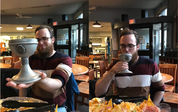 Dereck Oswick drinks from the goblet of knowledge following his PhD defence