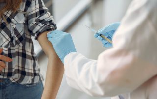 Person receiving a vaccination in their arm