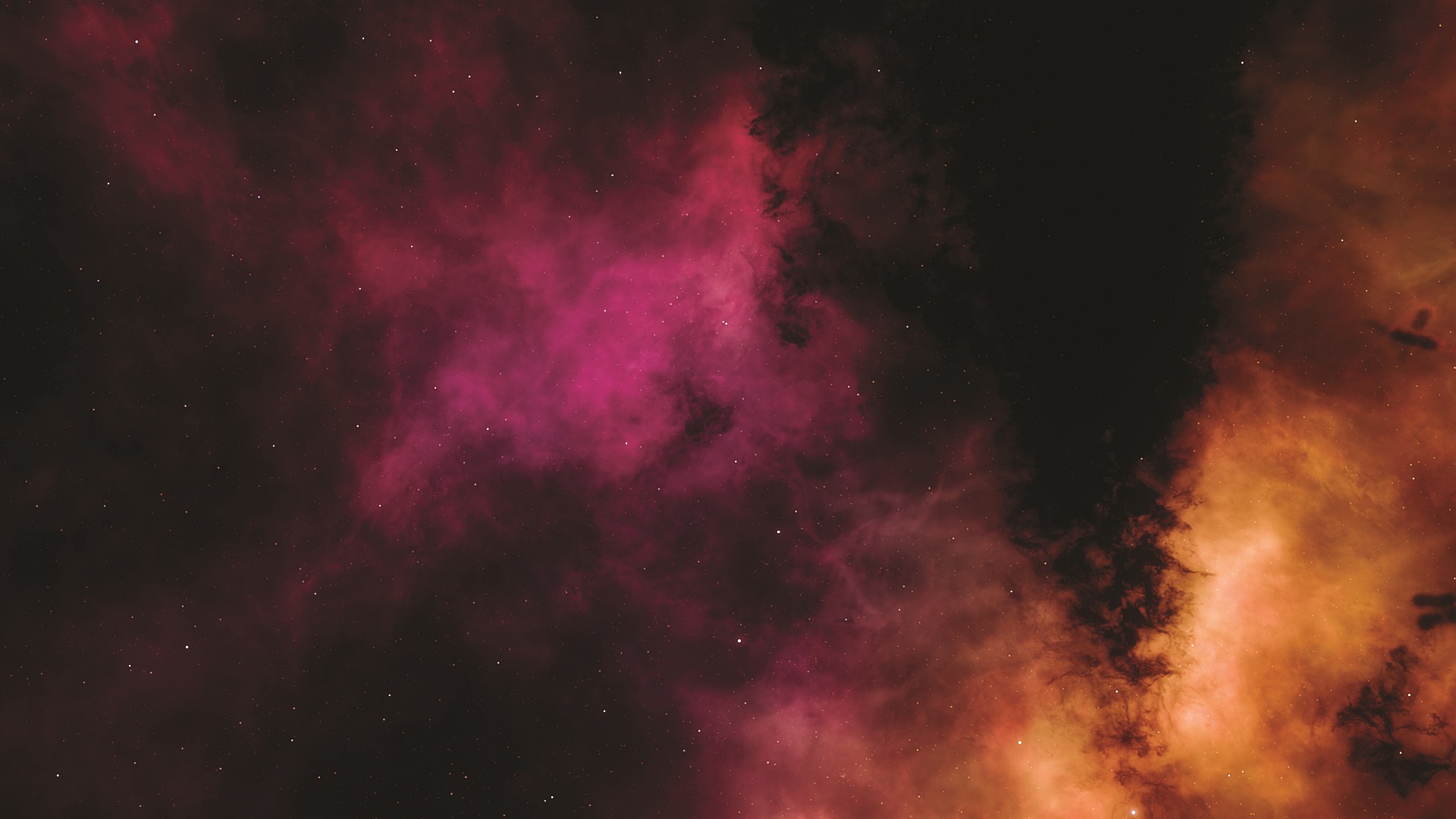 Black space with pink and orange nebula