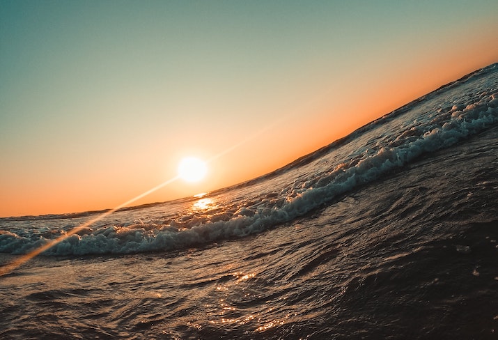 Ocean swell with setting sun in the background